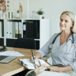 Female health professional in office talking to client