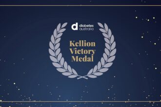Sign of Kellion Victory Medal on a black background with stars and a grey laurel wreath