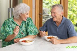 Couple chat over food.